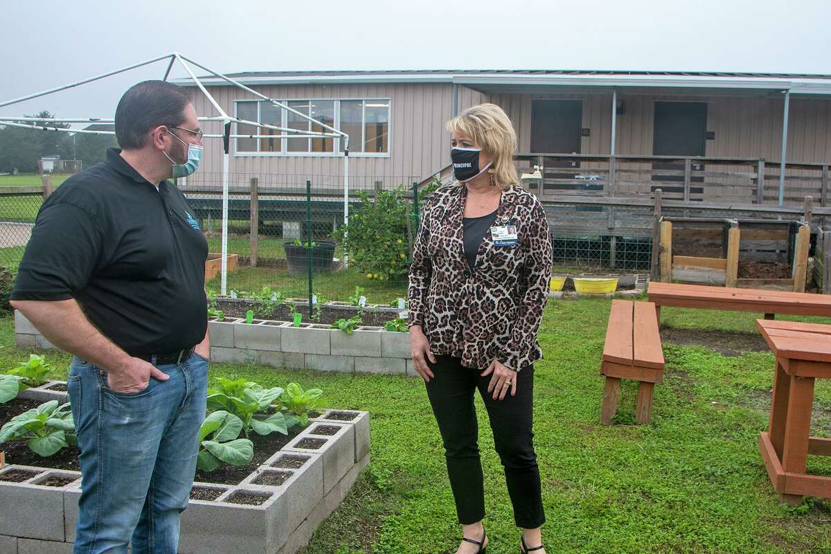 Owens Elementary School Principal Amy Frank, right, speaks with Crossbridge Christian Church Senior Pastor Kevin Pigg at the school’s outdoor garden. The church and school officially entered an Adopt-a-School partnership on Oct. 12 and improvements to the outdoor space are among plans to better the learning experience for Owens staff and students.
