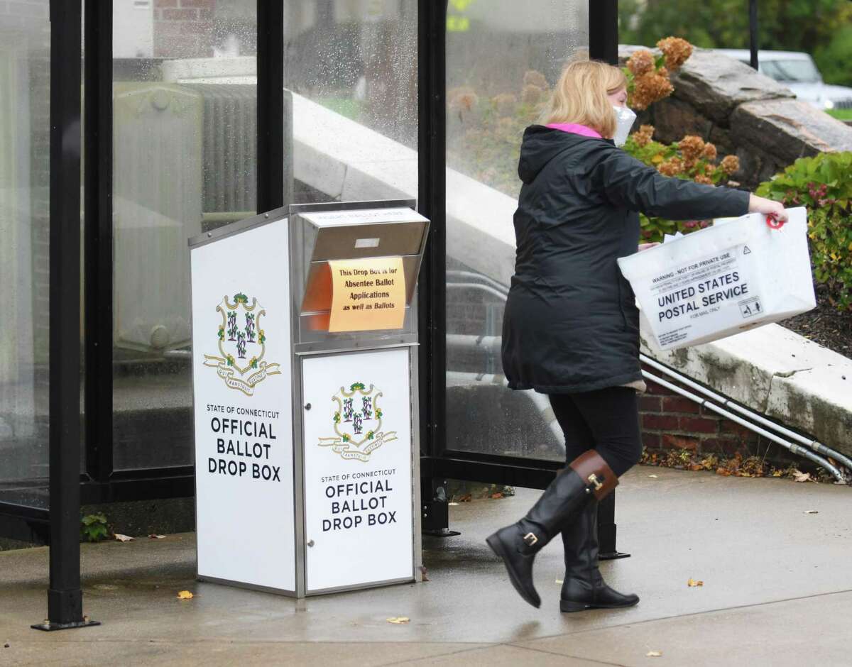 Ballots are picked up from the offical drop outside Town Hall in Greenwich, Conn. Wednesday, Oct. 28, 2020.