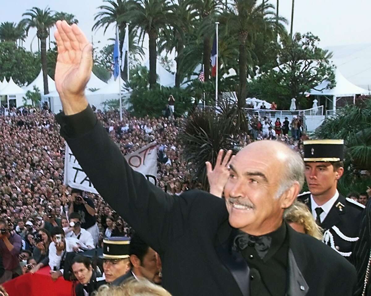 (FILES) In this file photo taken on May 14, 1999 British actor Sean Connery waves to the crowd on the steps of the Palais des Festivals before the screening of their movie "Entrapment" in selection for the 52nd Cannes Film Festival. - Legendary British actor Sean Connery, best known for playing fictional spy James Bond in seven films, has died aged 90, his family told the BBC on on October 31, 2020. The Scottish actor, who was knighted in 2000, won numerous awards during his decades-spanning career, including an Oscar, three Golden Globes and two Bafta awards. (Photo by Christophe SIMON / AFP) (Photo by CHRISTOPHE SIMON/AFP via Getty Images)