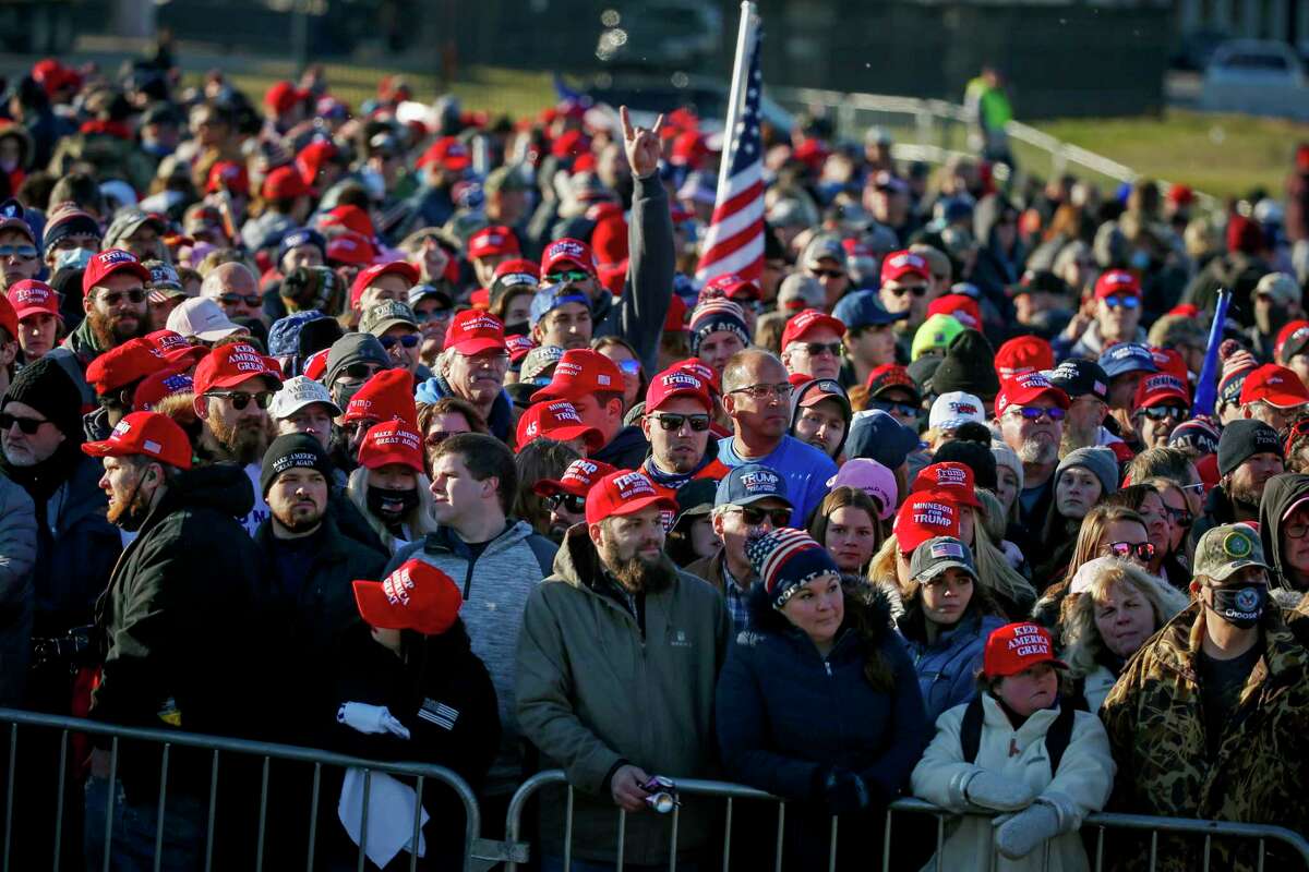 Supporters wait outside the airport before President Donald Trump speaks at a campaign rally Friday, Oct. 30, 2020, in Rochester, Minn.