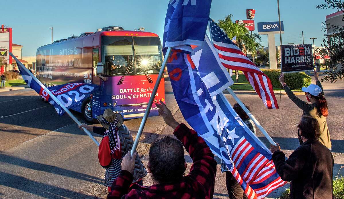 Supporters of presideintal candidate Joe Biden gather outside the Webb County Democratic Party Headquarters, Friday, Oct. 30, 2020, as they welcome the Biden for President Soul of the Nation tour bus.