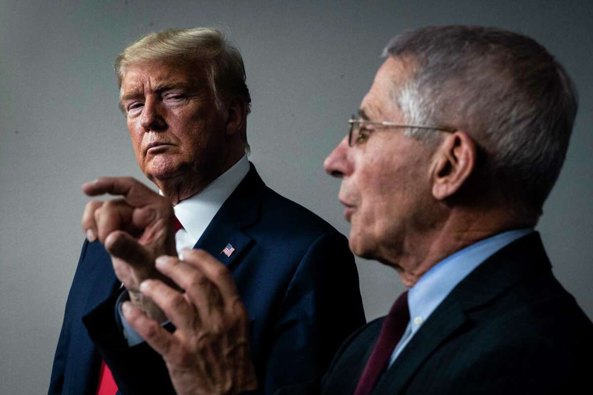 President Donald Trump listens as Dr. Anthony Fauci speaks with members of the coronavirus task force din March.