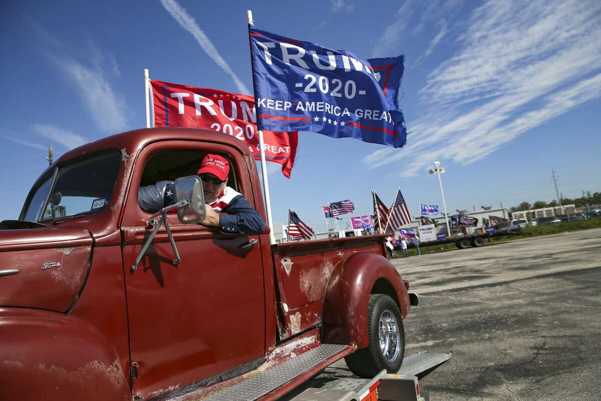 Mike Howell of Coolige, Texas, puts his 1942 Ford F-1 truck back on a trailer after participating in a Trump support rally around the 610 loop in Houston on Nov. 1, 2020.