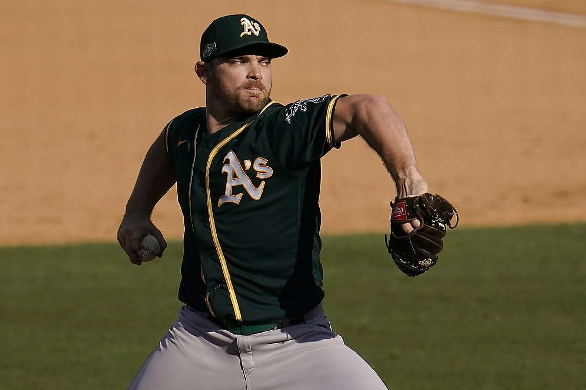 Oakland Athletics pitcher Liam Hendriks throws against the Houston Astros during the ninth inning of Game 3 of a baseball American League Division Series in Los Angeles, Wednesday, Oct. 7, 2020. (AP Photo/Marcio Jose Sanchez)