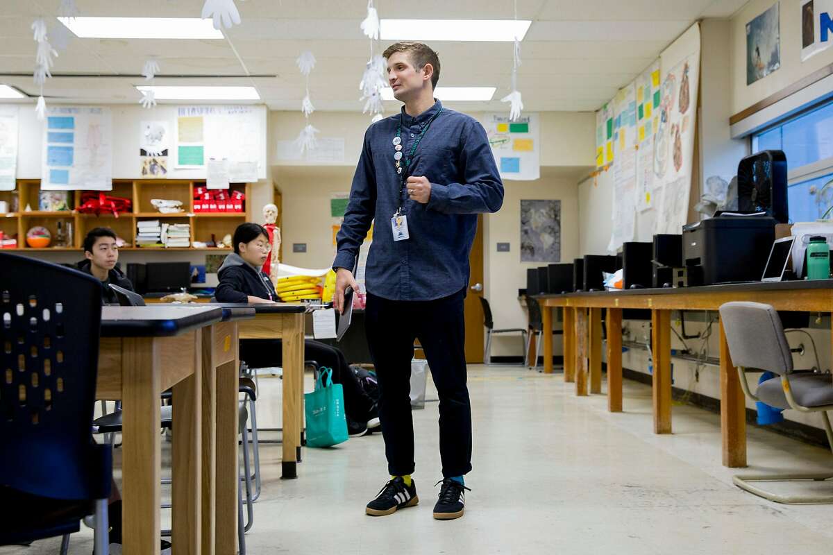 Health Science teacher Evan Mundahl works to educate his students on the coronavirus through group project work in his first period class at Phillip and Sala Burton Academic High School in San Francisco, March 11, 2020.
