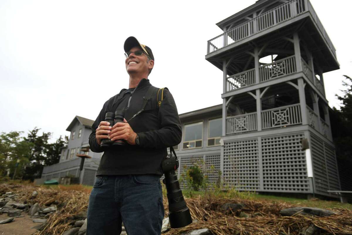 Board of Advisors member George Amato observes birds for a regular bird count at the Connecticut Audubon Coastal Center in Milford on Wednesday.