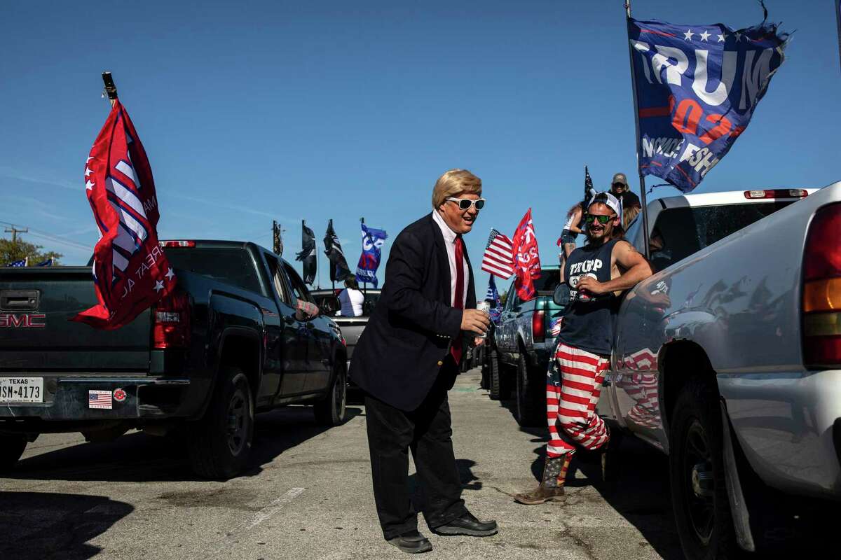 Michael Falato, dressed as President Donald Trump, as supporters of President Donald Trump gather before driving in a "Trump Train" caravan in San Antonio, Nov. 1, 2020. (Tamir Kalifa/The New York Times)