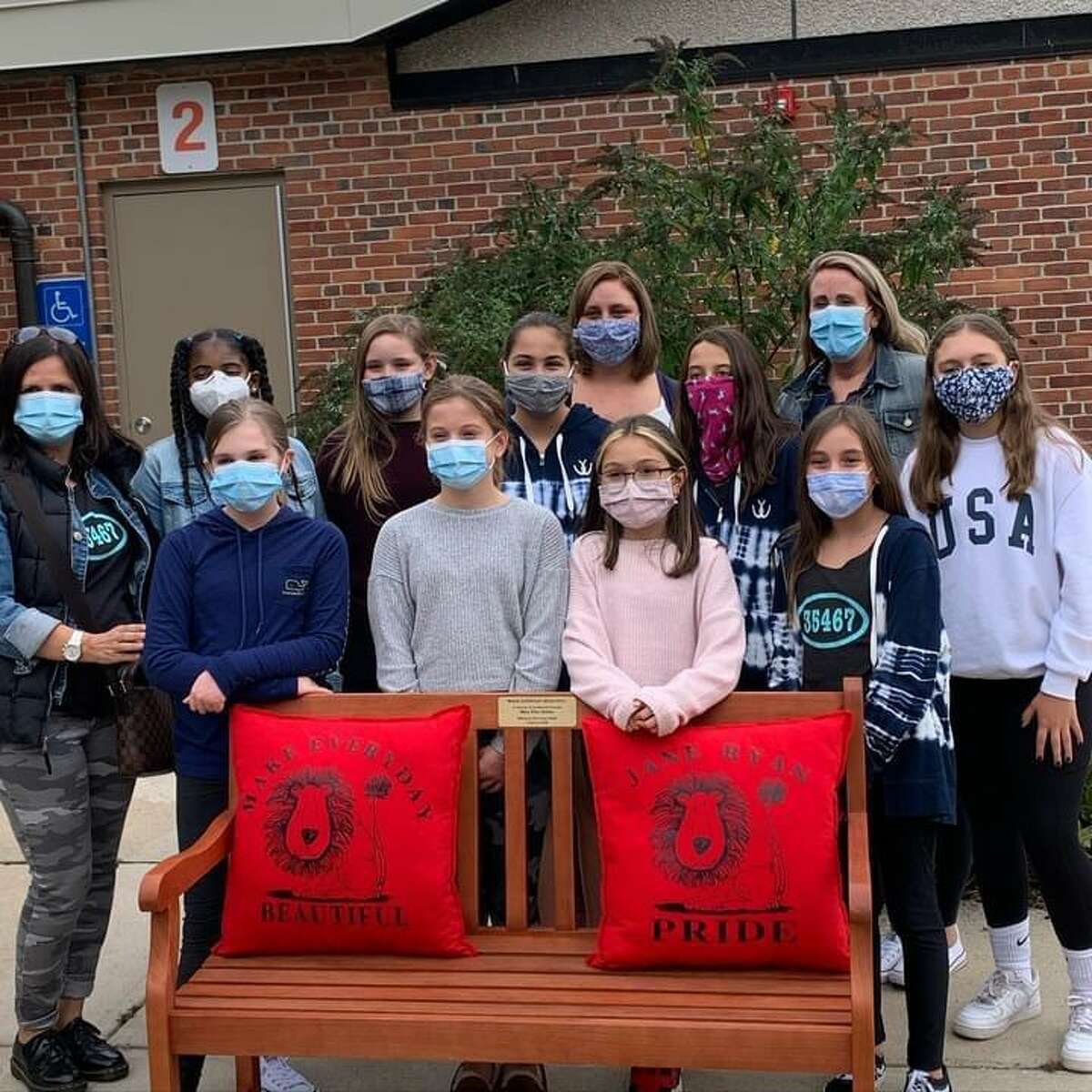 Jane Ryan Girl Scout Troop and recent graduates donate a bench in honor of Mrs. Bolton, their principal who recently passed away.
