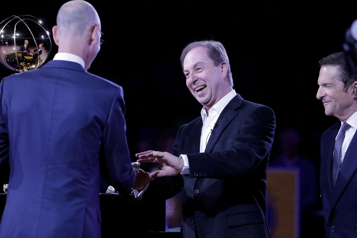 Warriors owner Joe Lacob smiles as he recieves his championship ring from NBA Commissioner Adam Silver before the Golden State Warriors played the Oklahoma City Thunder at Oracle Arena in Oakland, Calif., on Tuesday, October 16, 2018. The Warriors received their 2018 NBA Championship rings and saw their championship banner raised in the arena