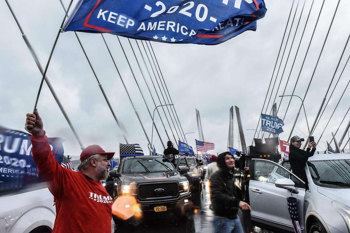 Trump supporters stop their vehicles and block traffic on the Tappen Zee Bridge also called the Governor Mario M. Cuomo Bridge on November 1, 2020 in Tarrytown, New York. With just two day left before the U.S. Presidential election, Trump supporters coordinated large caravans across the country dubbed "Maga drag." A similar caravan of flag-fluttering Trump partisans motored into a shopping mall parking lot in Marin City on Sunday morning. Witnesses said some members hurled racial epithets.