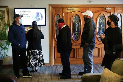 Family members of Matilde Cisneros line up on Thursday, Oct. 29, 2020, to sign the visitors’ book as they pay their last respects at Parches Funeral Home, after Cisneros died of coronavirus in El Paso.