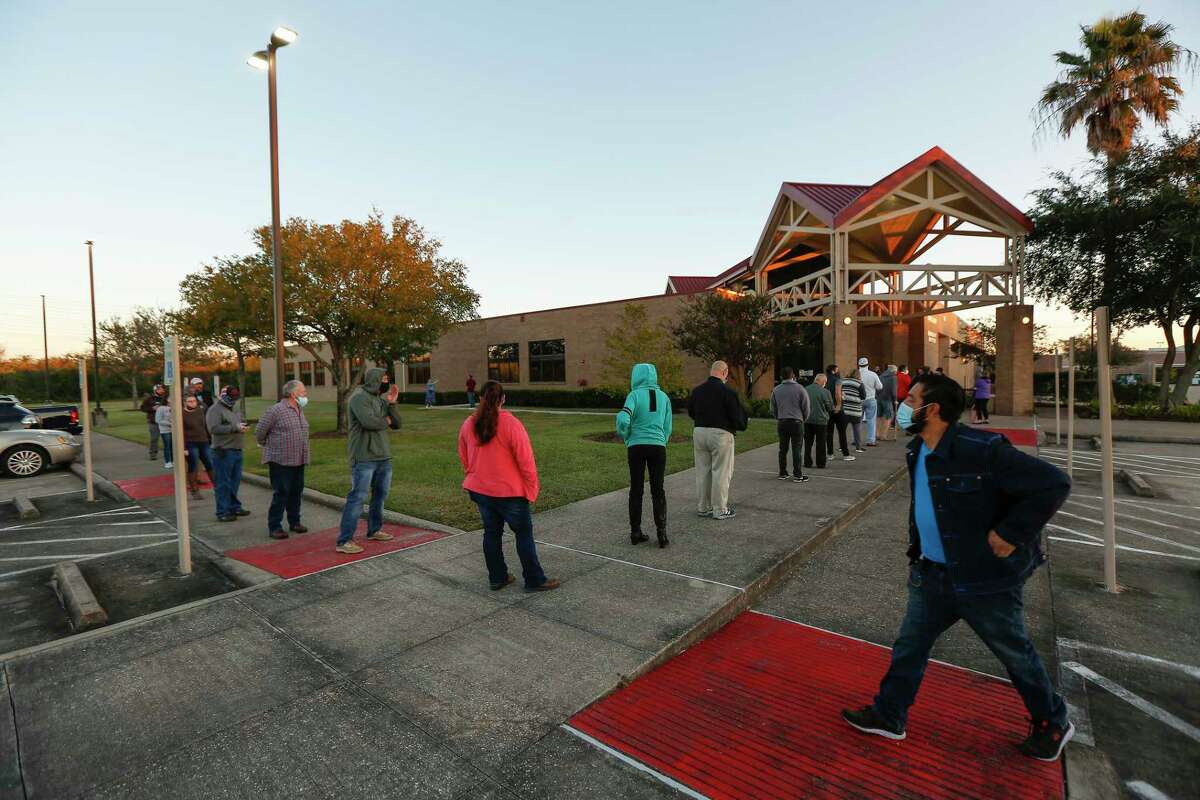 Voters arrive early and practiced social distancing at the Tom Reid Library Tuesday, Nov. 3, 2020, in Pearland.
