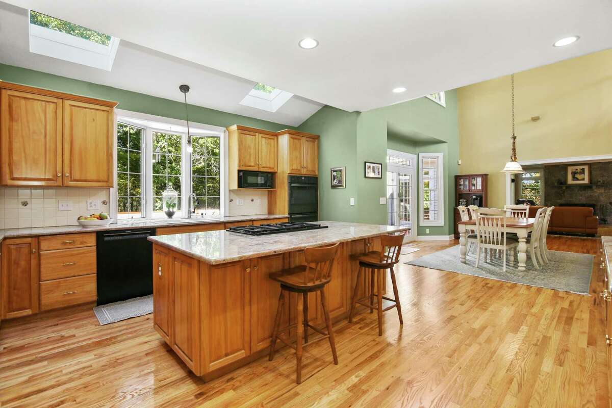 In the gourmet eat-in kitchen there is a center island/breakfast bar, granite counters, ample cabinets, a built-in desk area and a walk-in pantry. In the kitchen, there is a center island/breakfast bar, granite counters, ample cabinets, a built-in desk area, walk-in pantry, and a door to the deck in the casual dining area. On the main living level there are two half baths, which come in handy when entertaining. Upstairs, there are four bedrooms. The master suite features a tall tray ceiling, a ceiling fan, a sitting area, office, two walk-in closets, and a marble spa bath, which includes two separate vanities, dressing table, an oversized steam shower, jetted tub, skylight, and marble flooring. There is also a large bonus room that's perfect as a home office, second family room, art studio, media room, or playroom. Then again, the lower level features a large game, recreation or play room, and another room currently set up as a gym. There is plenty of space for a second home office or study area and lots of storage.