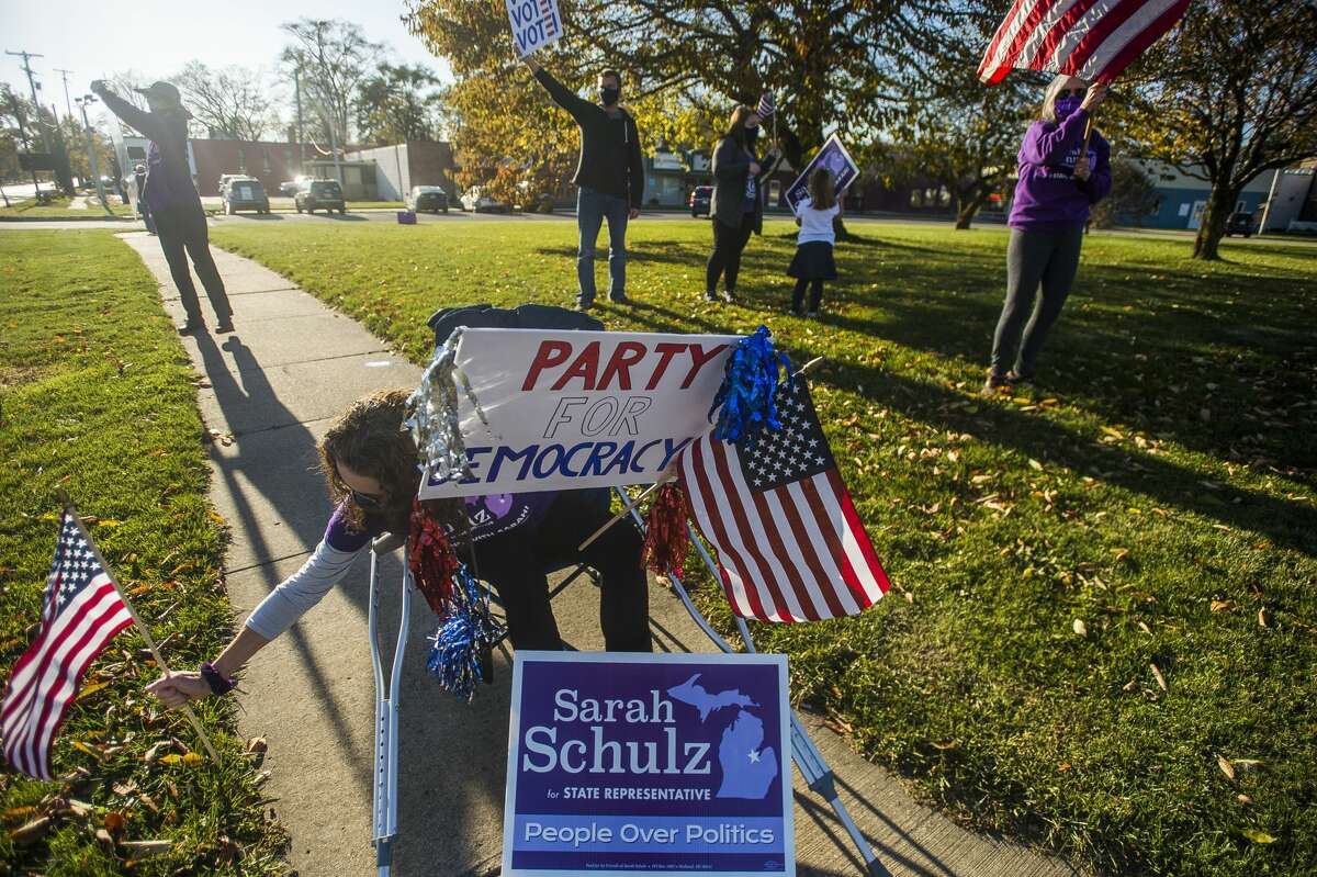 Volunteers and supporters of Sarah Schulz's campaign hold one of several rallies across town Tuesday, Nov. 3, 2020 at the corner of Ashman Street and Saginaw Road. (Katy Kildee/kkildee@mdn.net)