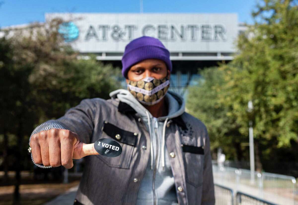 Spurs forward Rudy Gay displays his “I voted” sticker after voting at the AT&T Center.