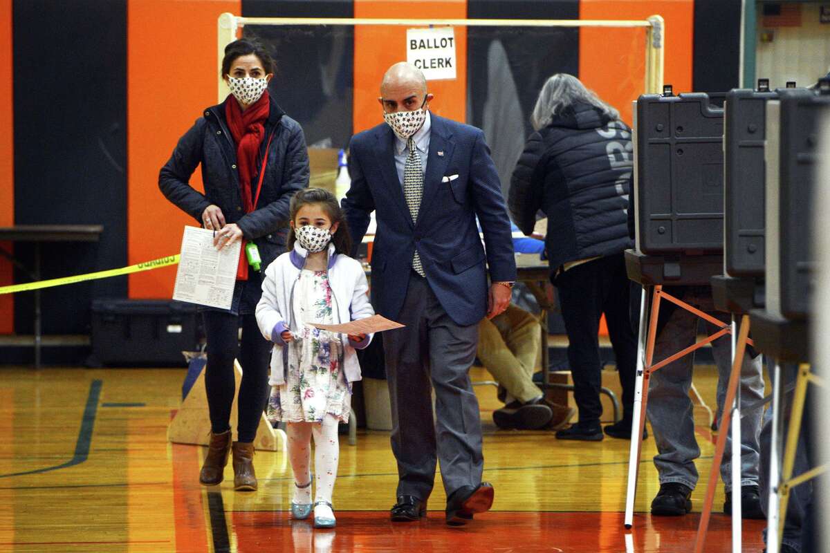 State Rep. Jason Perillo (R-113) is joined by his daughter, Lydia, as he and his wife, Becky, prepare to vote on Election Day at Shelton Intermediate School, in Shelton, Conn. Nov. 3, 2020.