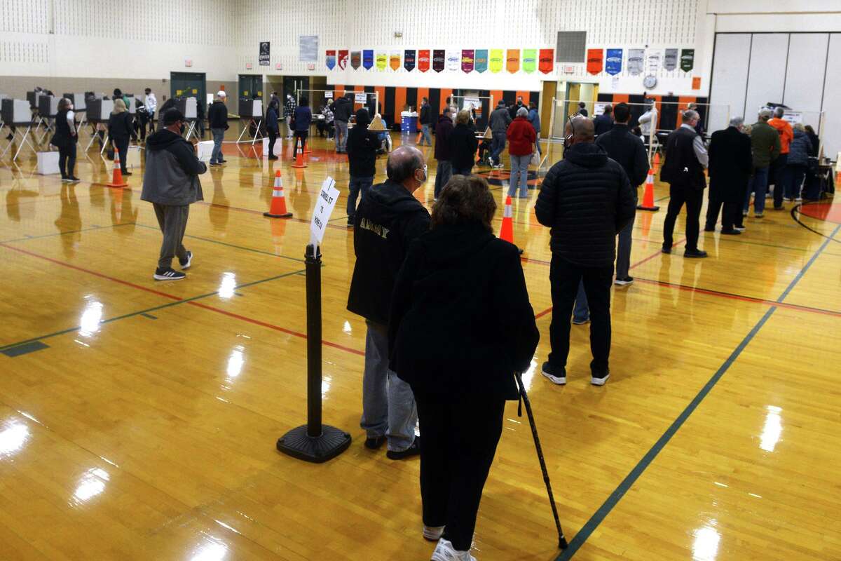 Voters wait in line on Election Day at Shelton Intermediate School, in Shelton, Conn. Nov. 3, 2020.