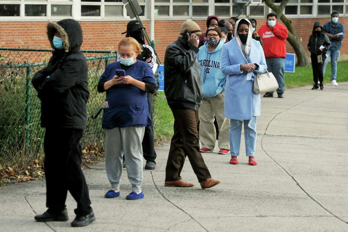 Voters line up on Election Day 2020 outside of Bassick High School, in Bridgeport, Conn. Nov. 3, 2020.