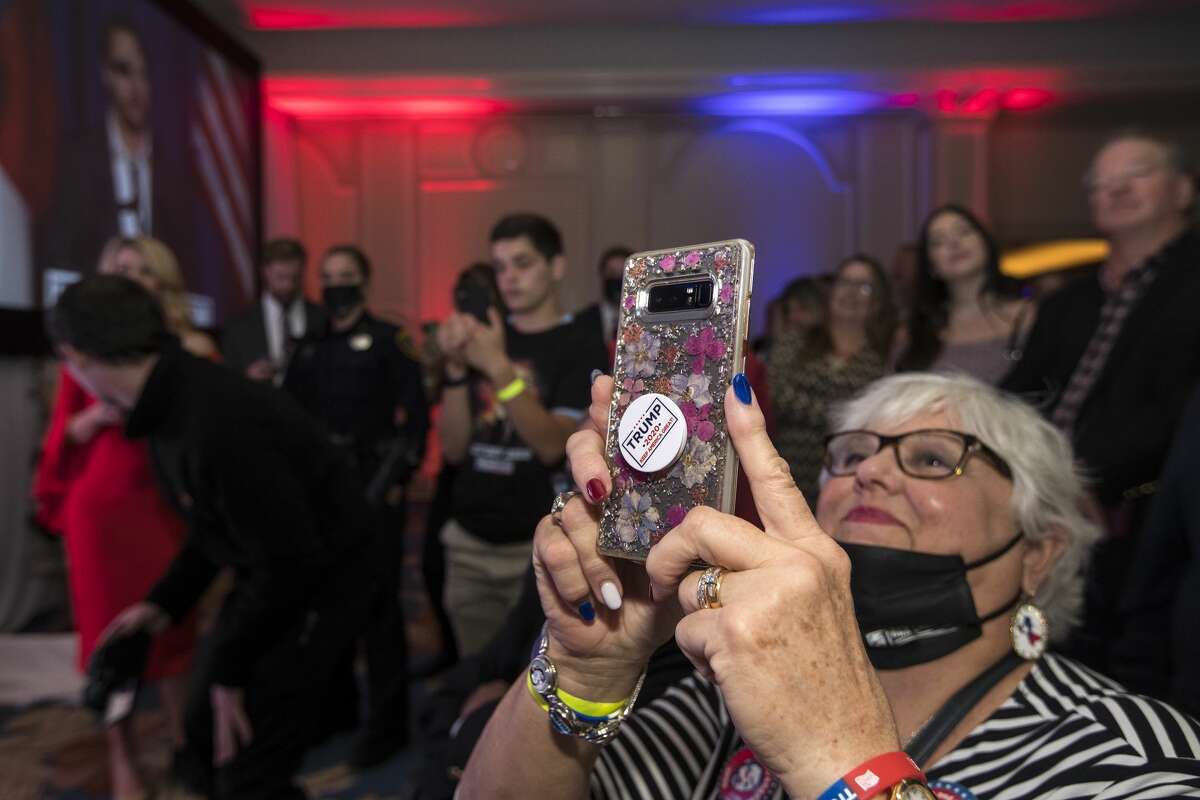 Supporters of Republican congressman Dan Crenshaw watch him speak as he celebrates his victory during an election watch party Tuesday, Nov. 3, 2020 in Houston.