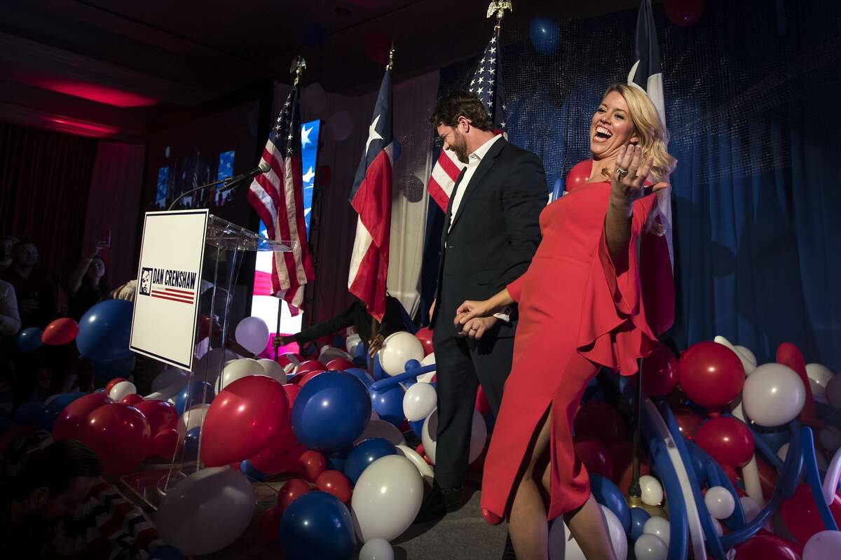 Republican congressman Dan Crenshaw and his wife, Tara, walk off the stage after speaking to his supporters to celebrate his victory during an election watch party Tuesday, Nov. 3, 2020 in Houston.