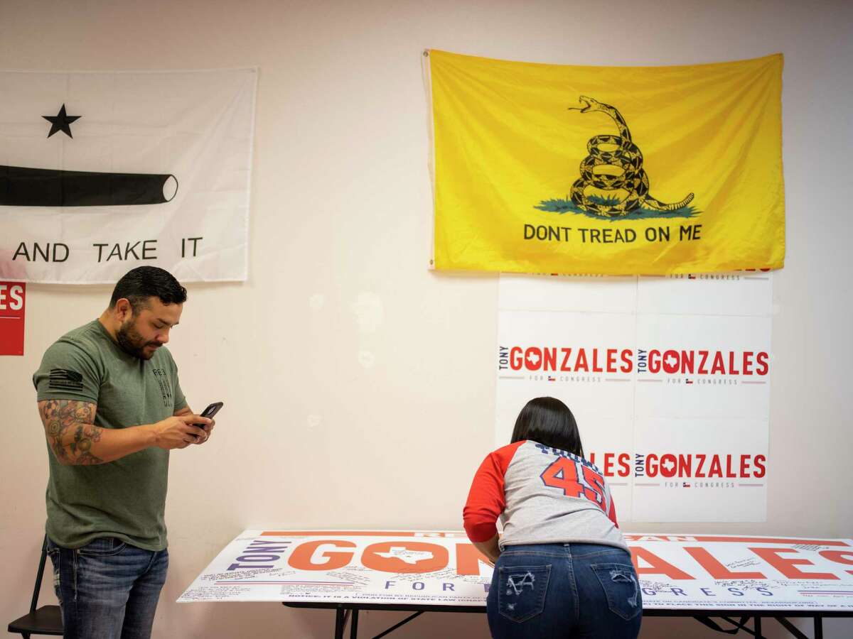 Supporters of Tony Gonzales, running for Congressional seat for District 23, sign a poster for him during an election night event on Tuesday, November 3, 2020 in San Antonio, Tx., U.S.
