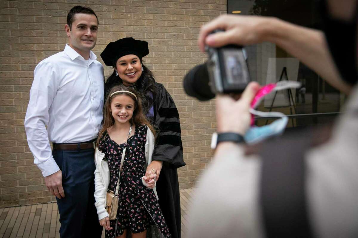 Matthew, Ashley and Blakely Reilly pose for a picture during a full day of commencement ceremonies for the South Texas College of Law Houston on Saturday, Oct. 17, 2020. The school celebrated with 13 commencement ceremonies over two days to honor COVID-19 graduates.