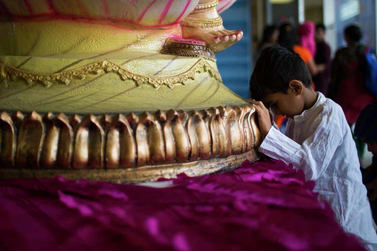 Anay Saranerkar, 5, makes a prayer as he arrives to the Diwali Festival of Lights event in Sugar Land, Saturday, Oct. 20, 2018.