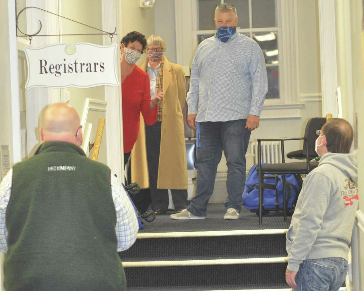 Election officials including Democratic Registrar Cindy Bruno, in red dress, and Republican Registrar Wayne Floegel, at top of stairs, worked late into election night. All the vote-counting and tabulating was finished up about 12:40 Wednesday morning.