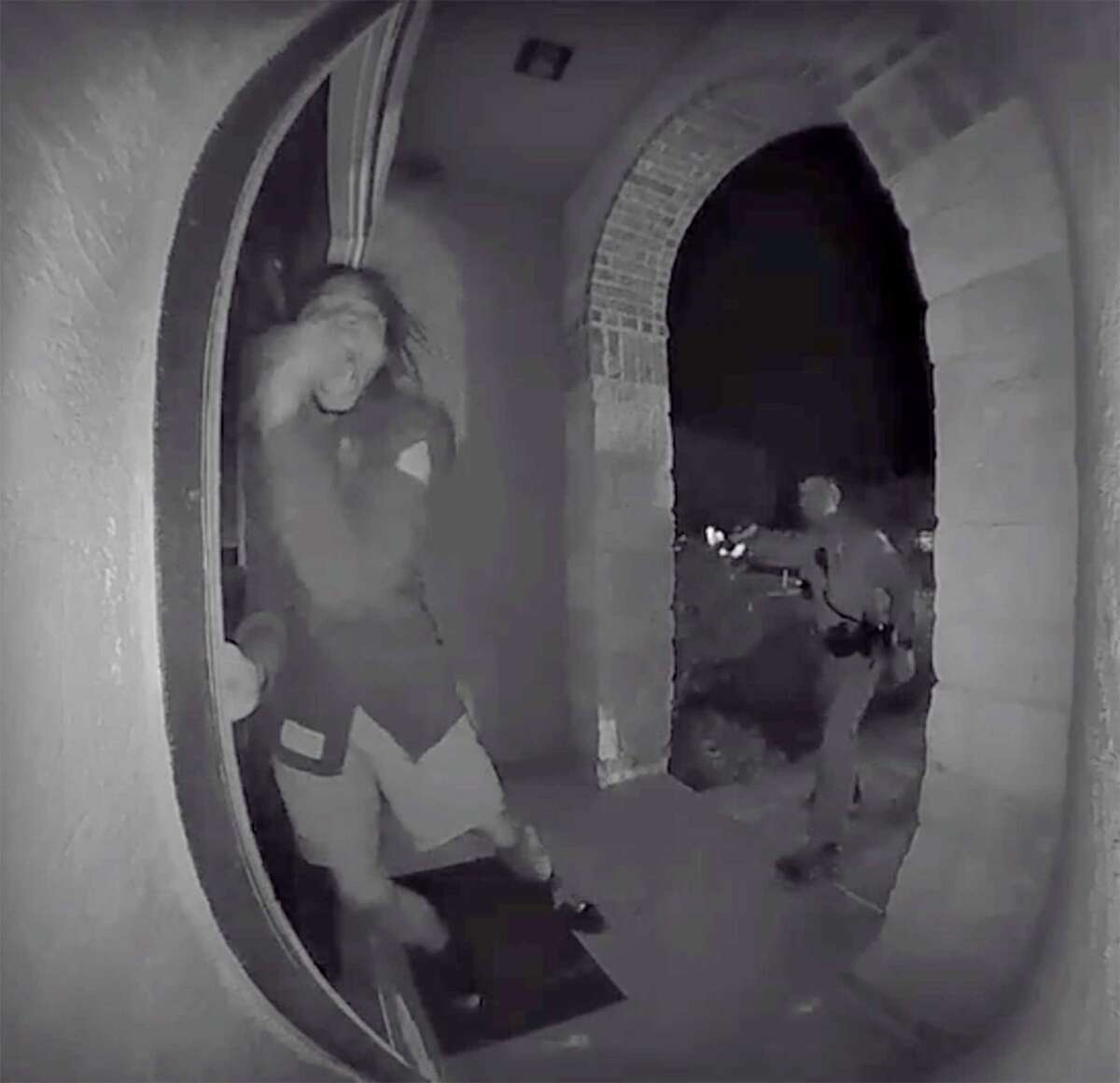 A screen grab from a home surveillance video shows a Schertz police officer using a Taser on Zekee Rayford, 18, as he pounds on the front door his home while calling for his parents.