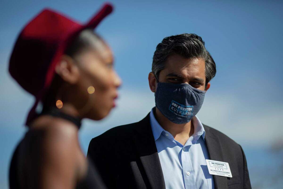 Democrat Sri Kulkarni, right, listens to voter Destiny Ilori, left, after she submitted her vote at a polling site on Tuesday, Nov. 3, 2020, in Houston. Kulkarni lost his bid for Texas’ 22nd Congressional District to Republican Fort Bend County Sheriff Troy Nehls.