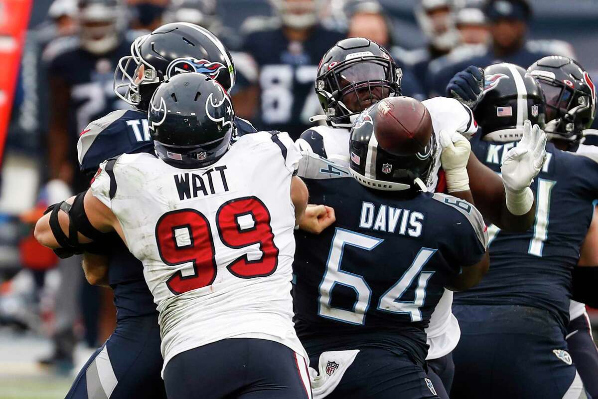 Texans defensive end J.J. Watt (99) sacks Titans quarterback Ryan Tannehill, forcing a fumble and a turnover.