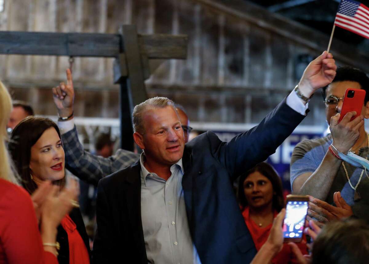 Republican Troy Nehls waves a U.S. flag while celebrating his win the race for congress, during his watch party at Freedom Hall on Tuesday, Nov. 3, 2020, in Richmond, Texas.