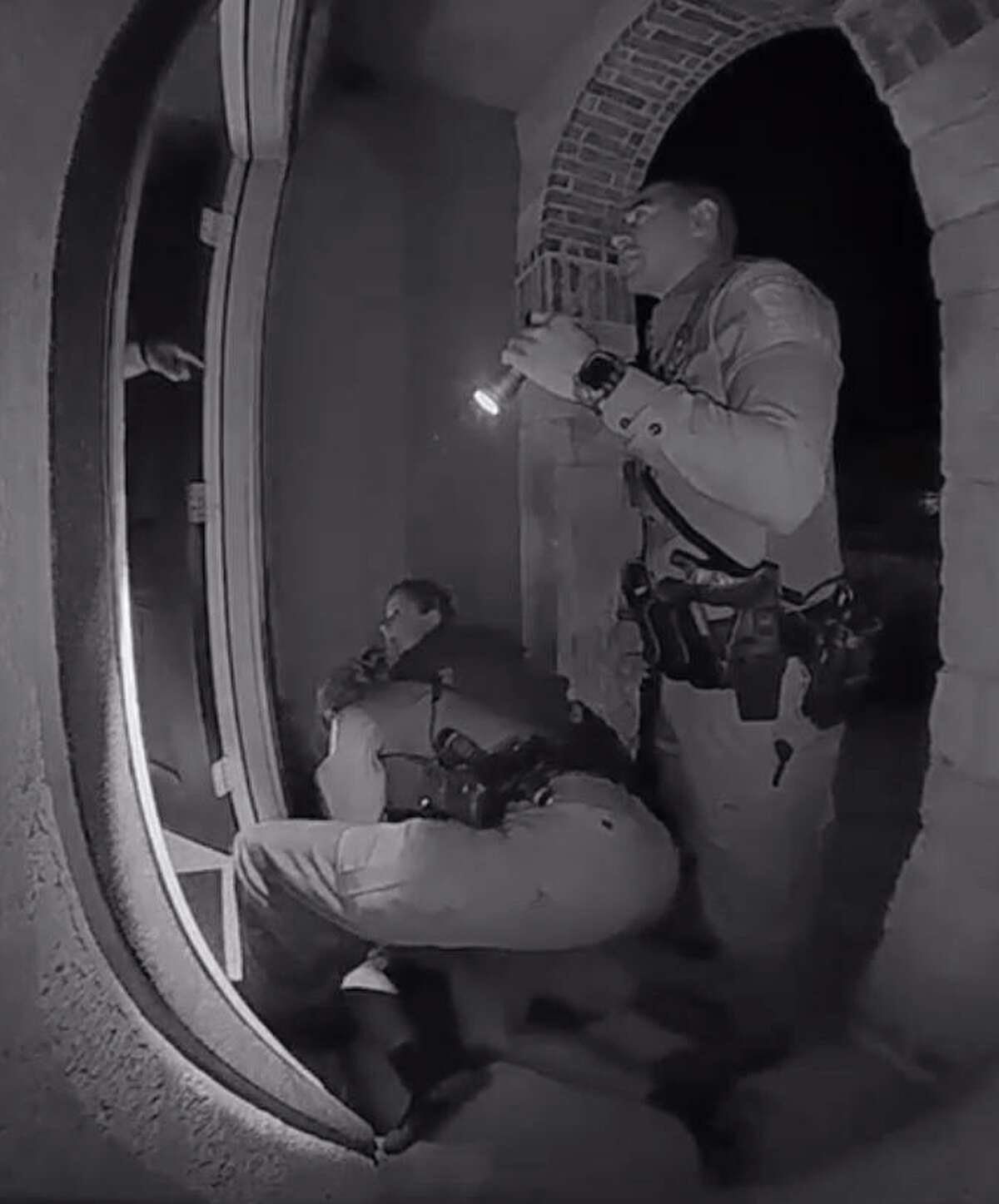 Screen grabs from a home surveillance video show Schertz police officers interacting with the parents of 18-year-old Zekee Rayford after chasing and arresting him on the front steps of the Rayford's home.
