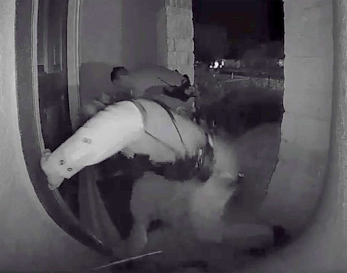 Screen grabs from a home surveillance video show a Schertz police officer kicking Zekee Rayford, 18, on the front steps of his home.