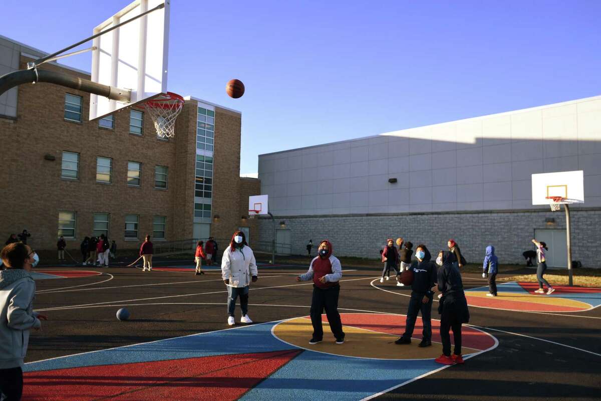 Students have fun with a game of basketball on the playground during the afterschool program at Barnum and Waltersville Schools in Bridgeport, Conn. on Monday, November 2, 2020.