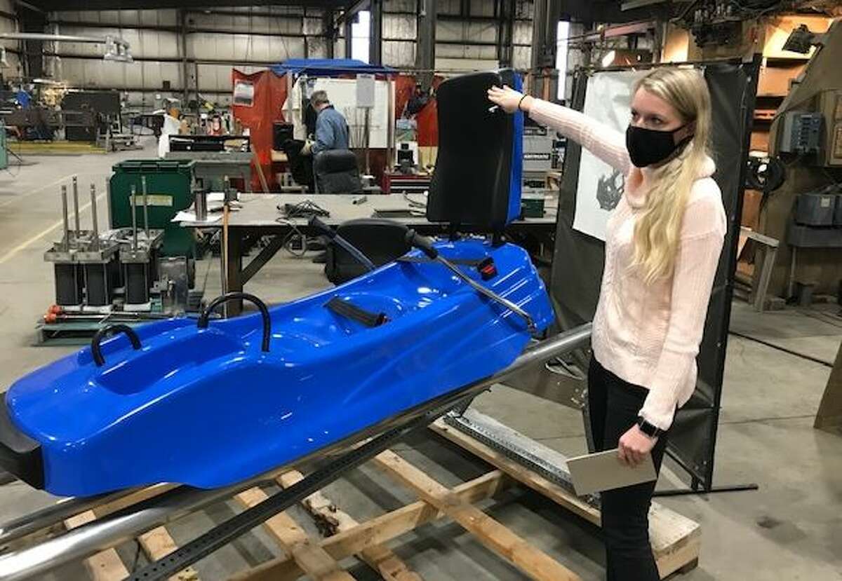 ADG spokeswoman Julie St. Louis shows a Cliffside Coaster being built in the company's Cohoes fabrication plant.