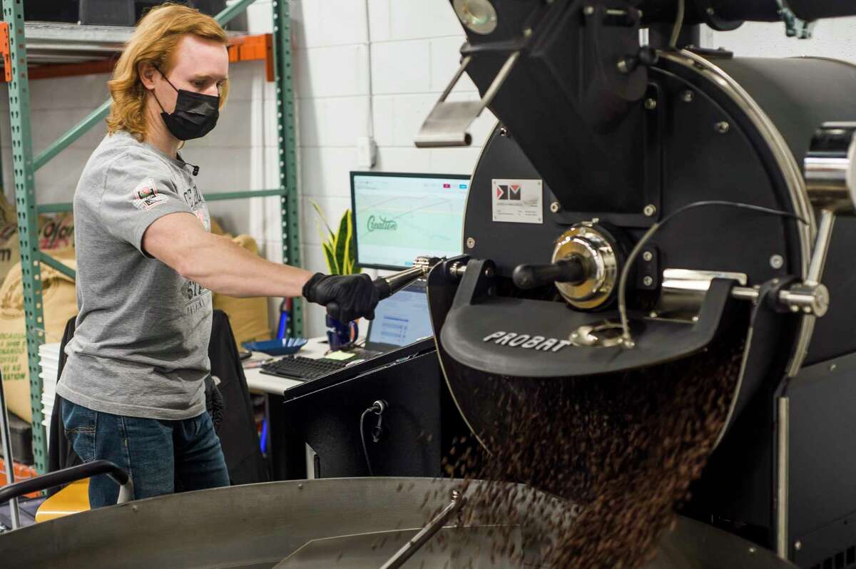Kyle Woodward roasts a batch of coffee beans Thursday inside Creation Coffee at 5023 Eastman Ave. in Midland. (Katy Kildee/kkildee@mdn.net)
