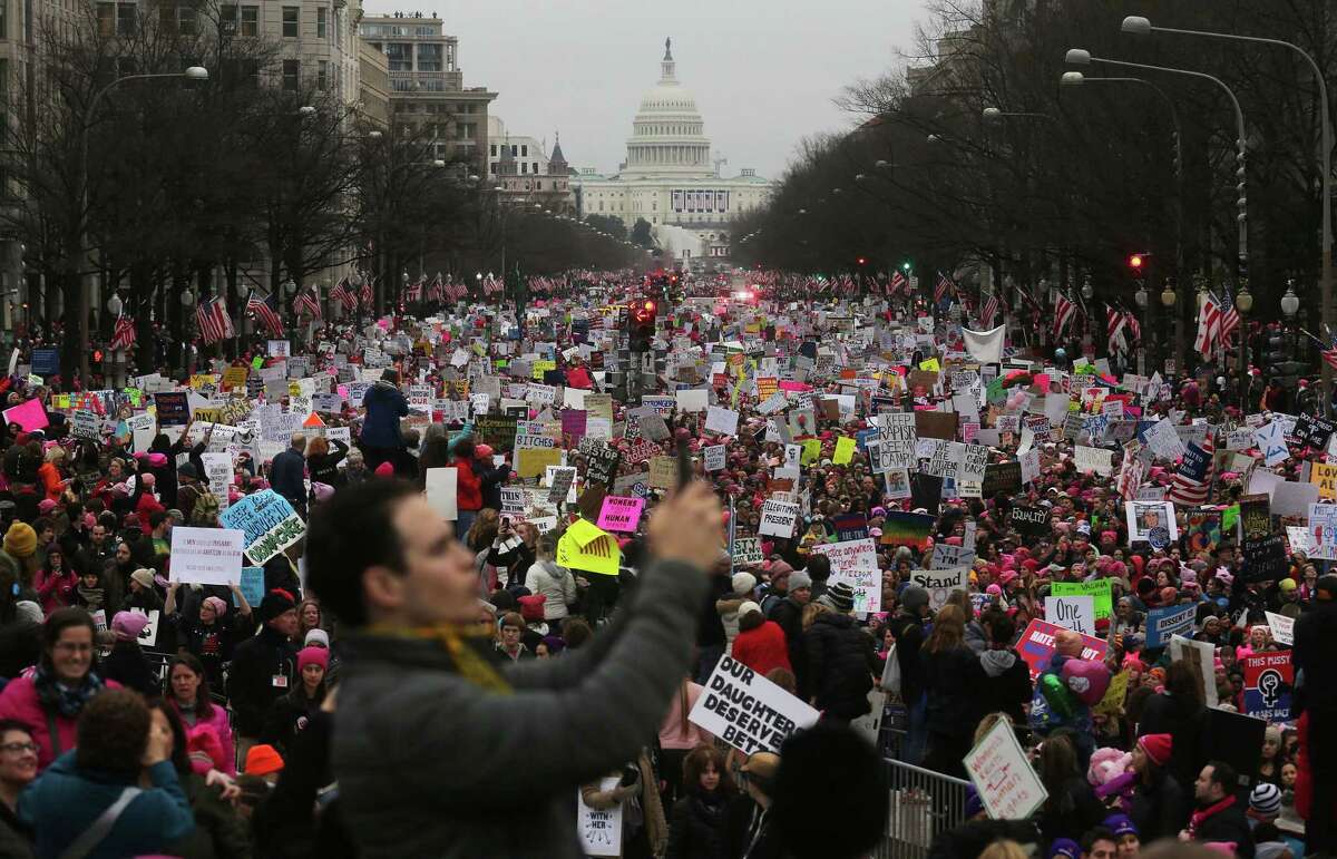 Protesters walk during the Women’s March on Washington, with the U.S. Capitol in the background, on Jan. 21, 2017 in Washington, D.C. Large crowds attended the anti-Trump rally a day after Donald Trump was sworn in as the 45th U.S. president.