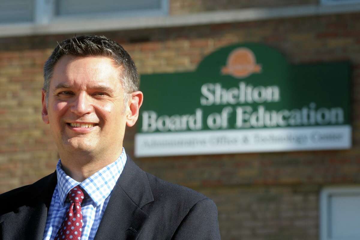 Newly promoted Superintendent of Schools Ken Saranich poses in front of the Board of Education offices in Shelton, Conn. Nov. 5, 2020.