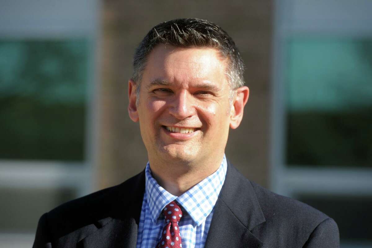 Newly promoted Superintendent of Schools Ken Saranich poses in front of the Board of Education offices in Shelton, Conn. Nov. 5, 2020.