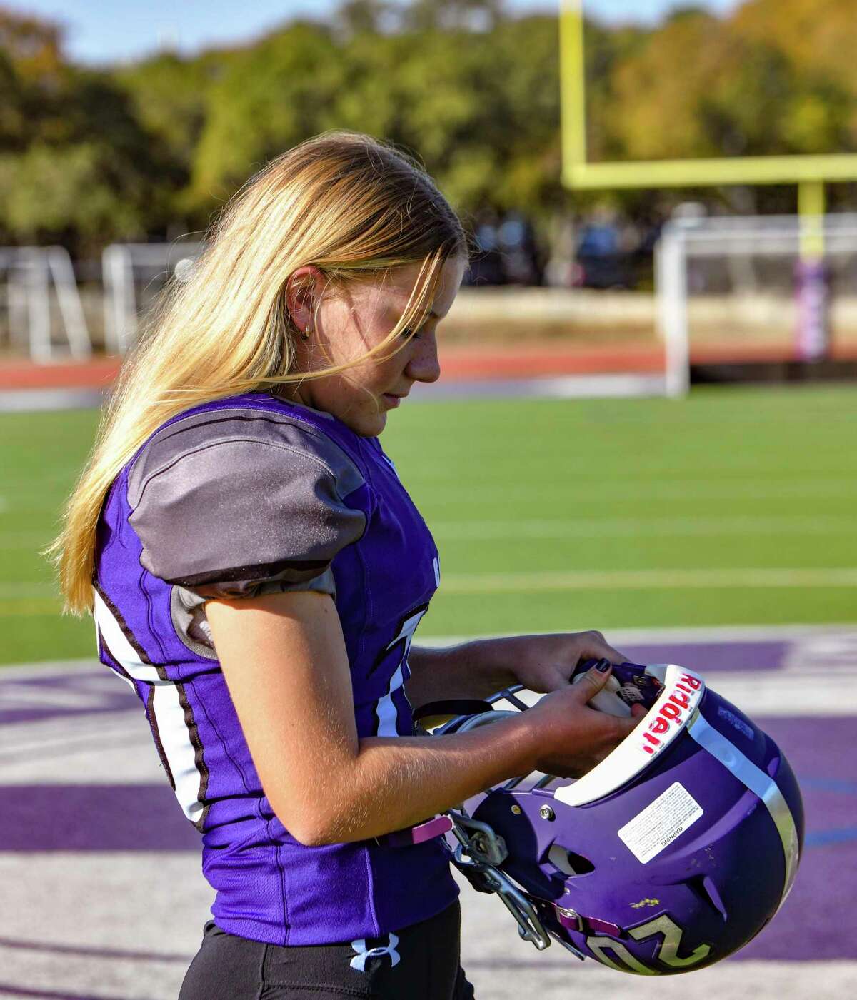 Saint Mary's Hall kicker Hunter Hoelscher, a star on the school's girls soccer team, dons her helmet on Wednesday, Nov. 4, 2020.