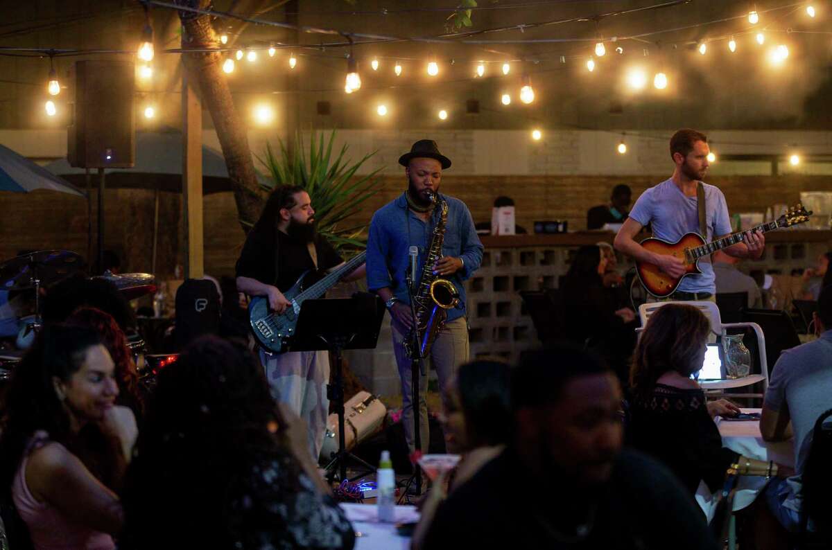 Customers enjoy live music while dining on the patio of Lucille's.