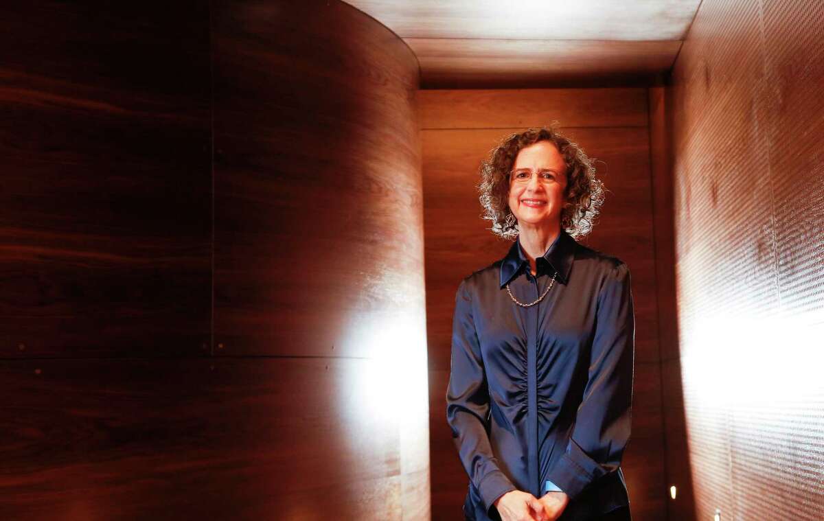 Deborah Brochstein stands in the MFAH Kinder Building’s Lynn Wyatt Theater, where her woodworking company’s American black walnut lines the walls.