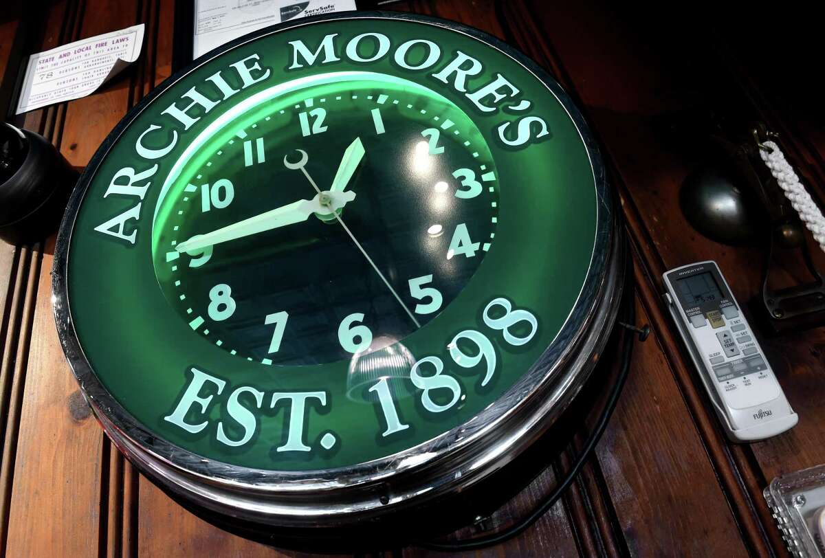 An Archie Moore clock hangs at the end of the bar during the restoration of the historic restaurant on Willow Street in New Haven on November 5, 2020.