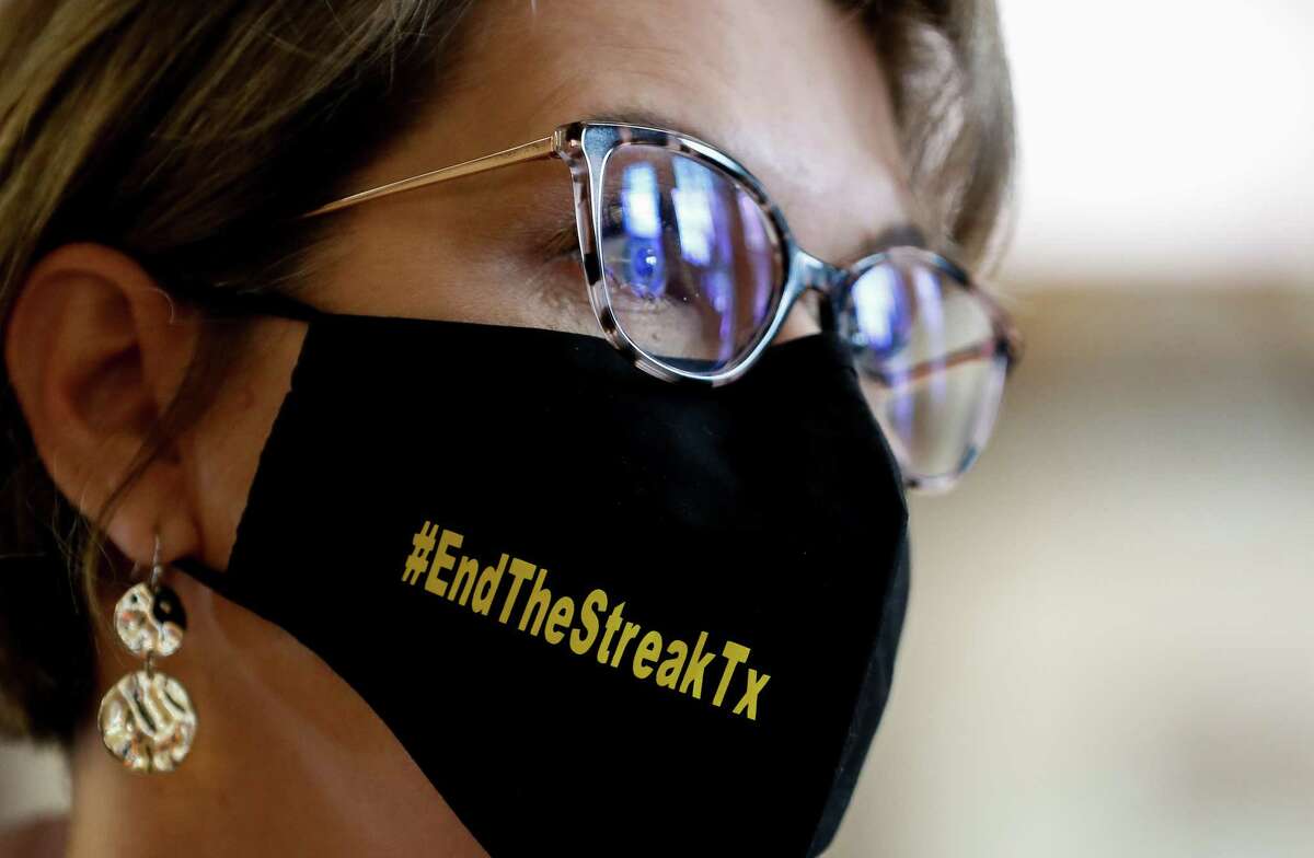 Texas Transportation Commissioner Laura Ryan wears a #EndTheStreakTx face mask inside Houston City Hall, following a press conference where officials talked to reporters about roadway fatalities in the city and the state, on Nov. 5, 2020. The last time no one died on a Texas road was Nov. 7, 2000.