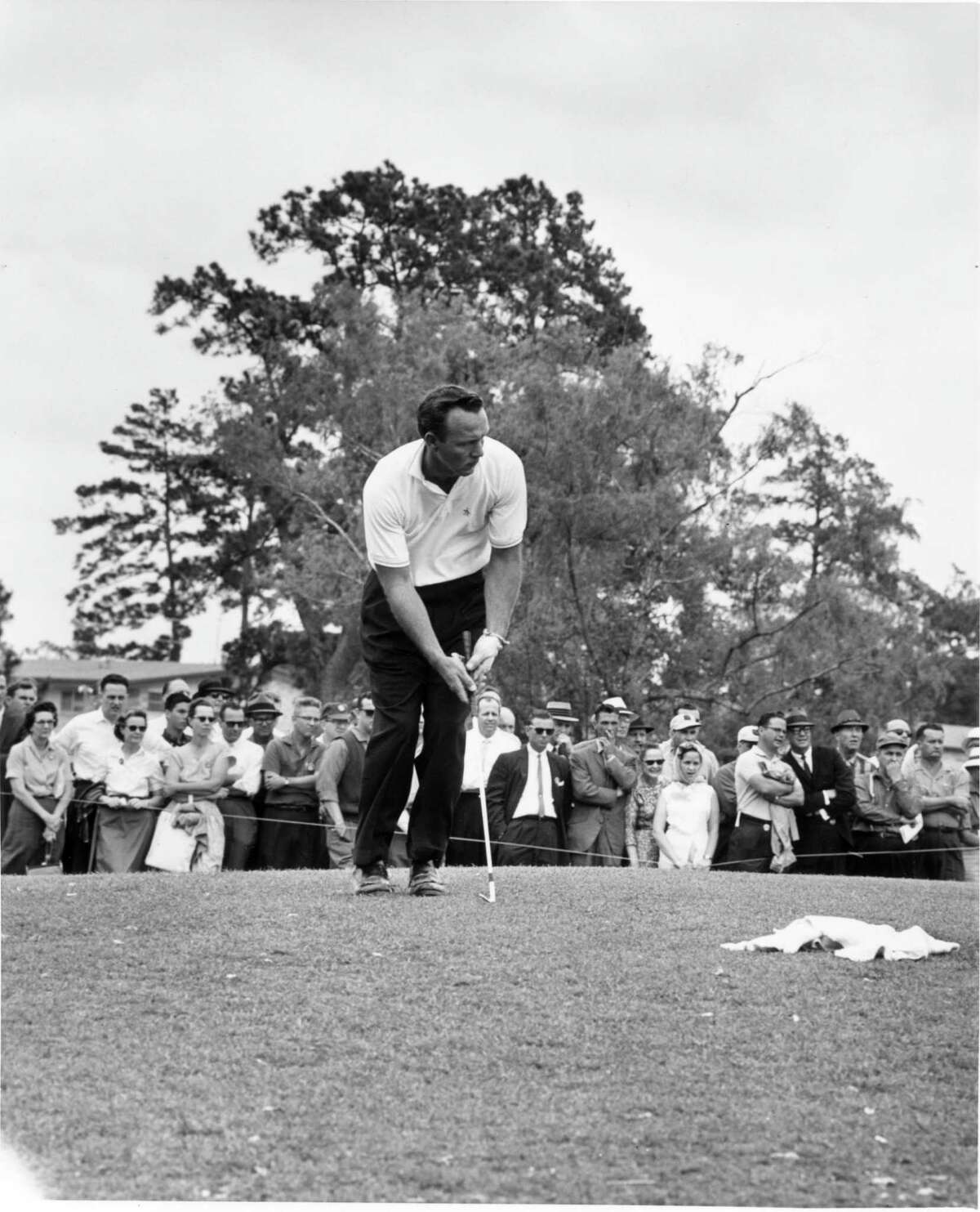 Golfing legend Arnold Palmer chips onto the ninth green of the Memorial Park golf course during the 1961 Houston Open. He won the event in 1957 and 1966.