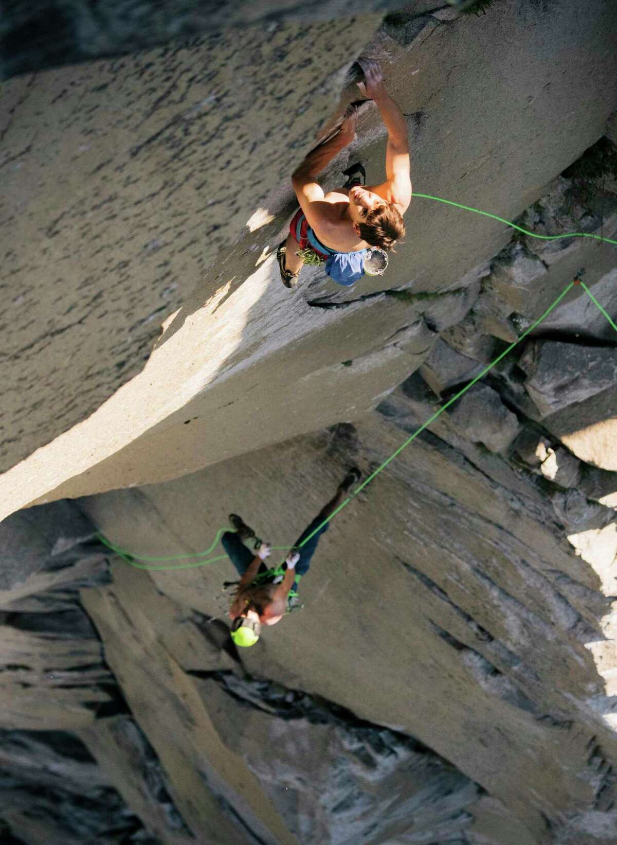 In this June 3, 2018 photo provided by Corey Rich, Alex Honnold, top and Tommy Caldwell climb The Nose of El Capitan in Yosemite National Park, California.