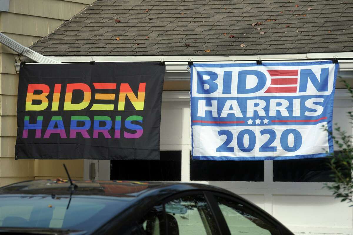 Bidden/Harris 2020 presidential election banners hang in front of a home in Milford, Conn., Oct. 21, 2020.