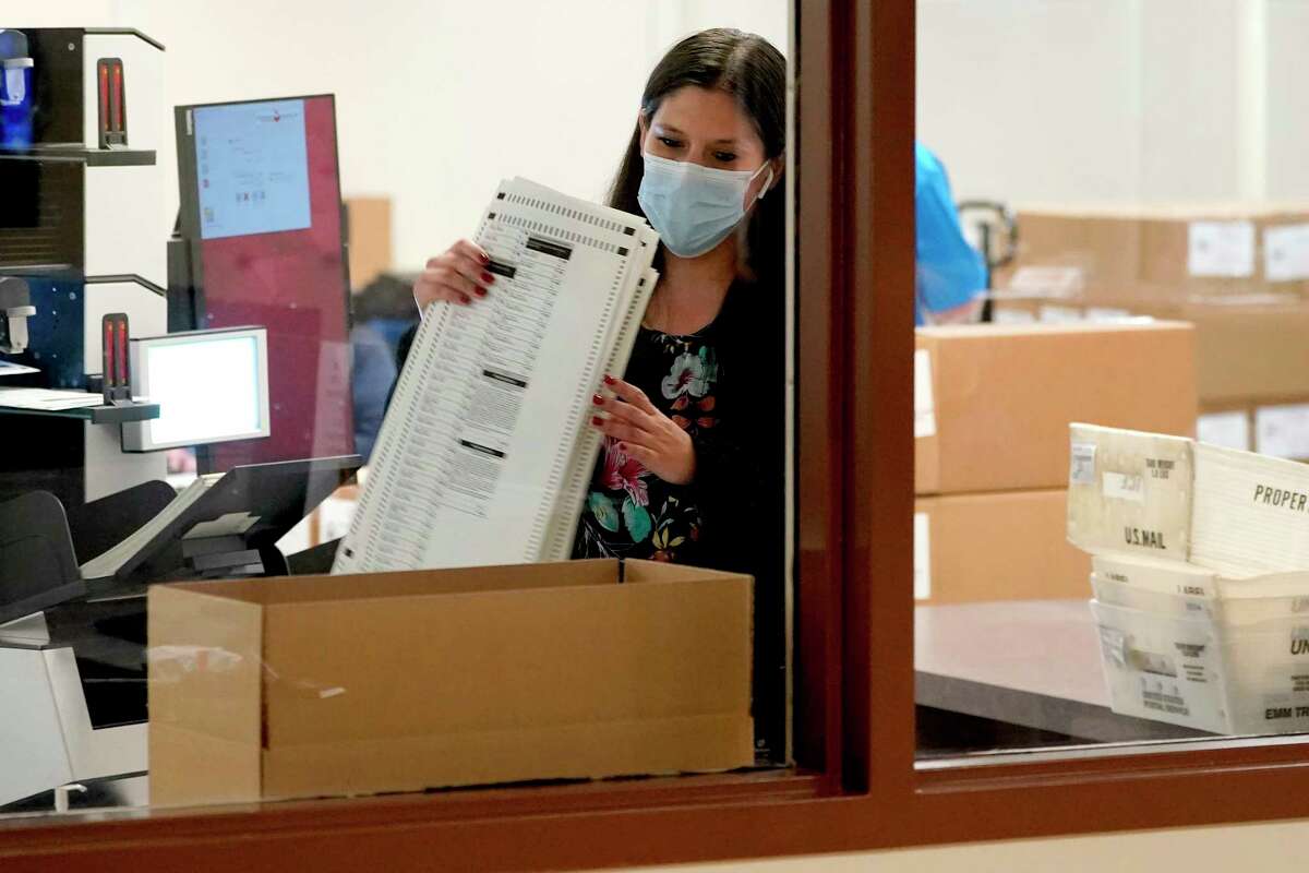 Maricopa County elections officials count ballots, Wednesday, Nov. 4, 2020, at the Maricopa County Recorders Office in Phoenix. (AP Photo/Matt York)