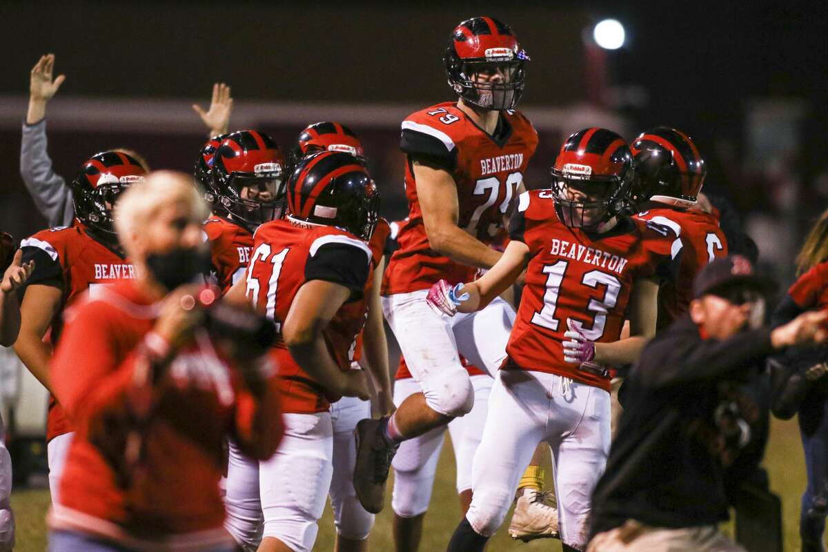 The Beaverton sideline celebrates after a touchdown during a game against Oscoda Friday, Nov. 6, 2020 at Beaverton High School. (Cody Scanlan/for the Daily News).